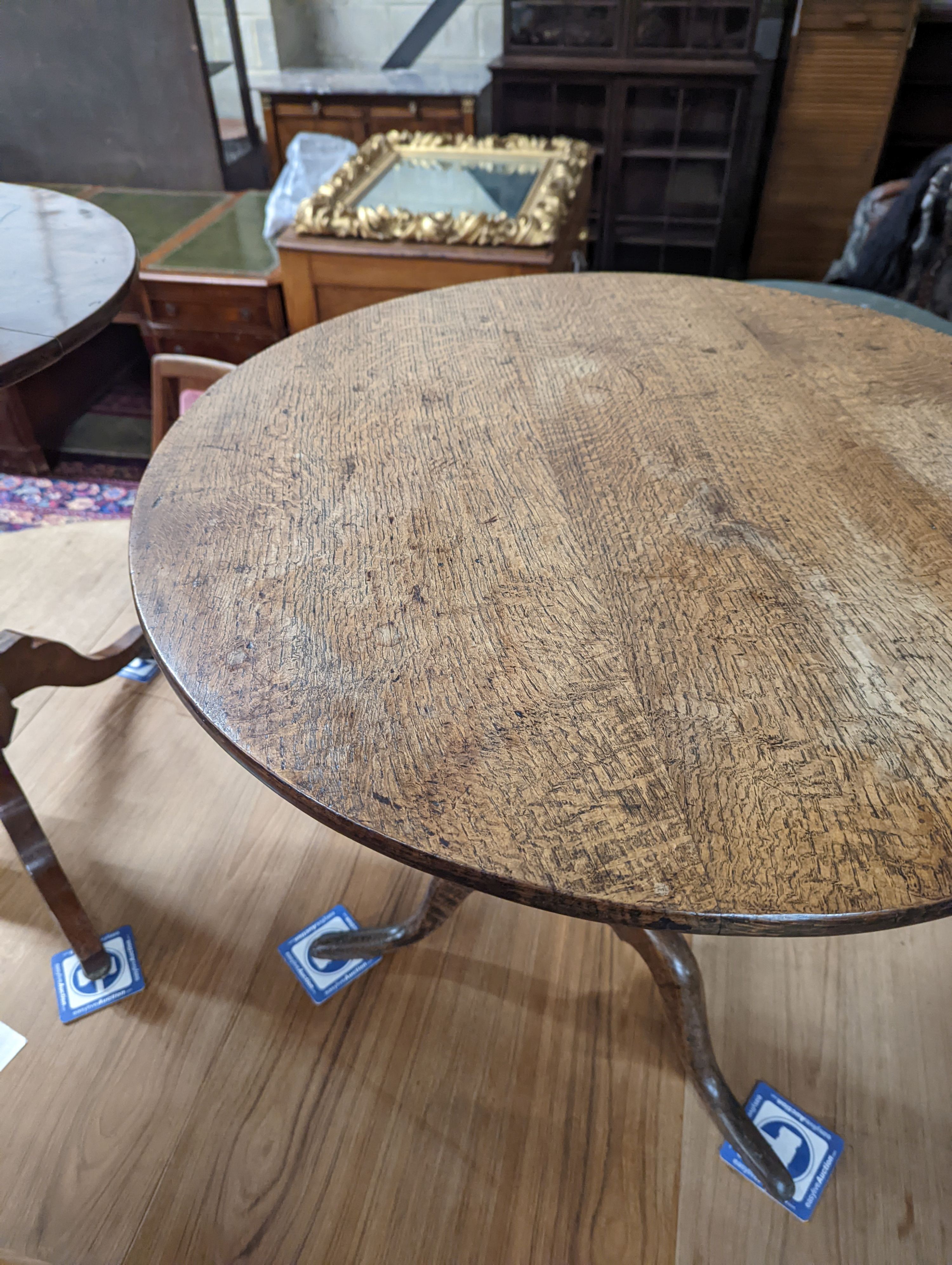 A George III circular oak tilt top tea table, diameter 74cm, height 66cm